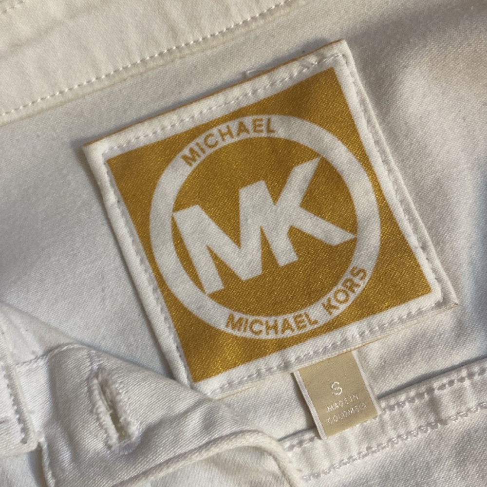 Barely worn Michael Kors white jean jacket with gold buttons.
